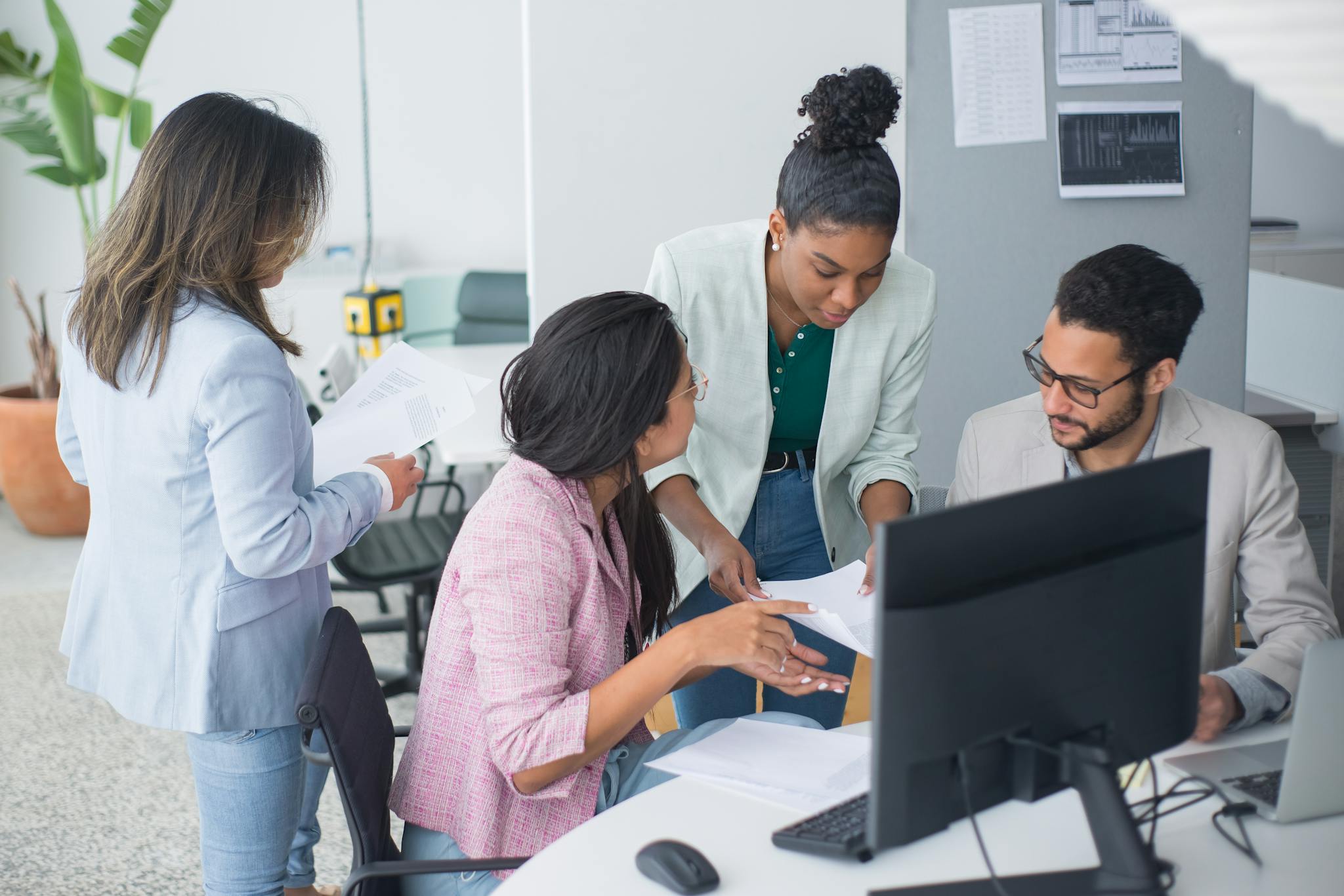 A diverse team engaged in a lively discussion in a modern office setting, fostering collaboration and teamwork.