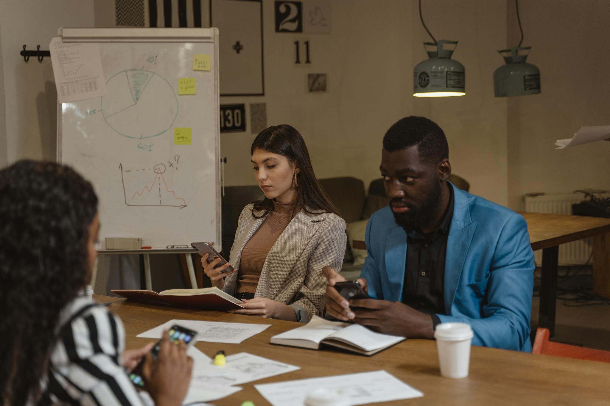 Multicultural team discusses business strategy in a modern office setting.